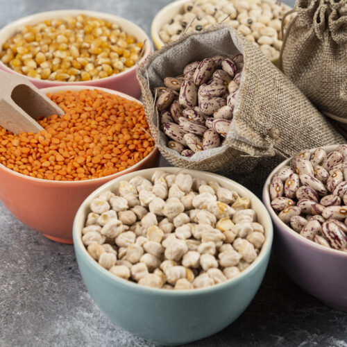 Assortment of raw dry legumes composition on marble surface. High quality photo